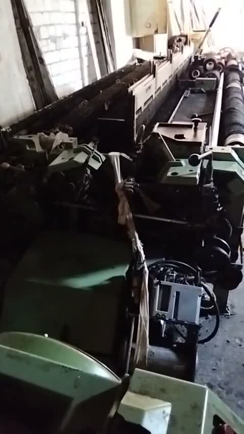 Row of Sulzer projectile looms in the weaving mill, walkthrough